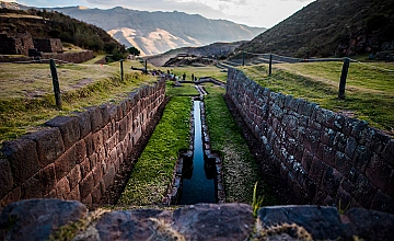 Corredor de piedra en Pikillacta, Cusco, con muros preincas y vista al valle andino