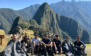 Viajeros en Machu Picchu con vista al Huayna Picchu, foto grupal panorámica